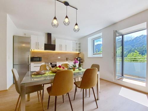 a kitchen and dining room with a table and chairs at Apartment Halbeis by Interhome in Matrei am Brenner