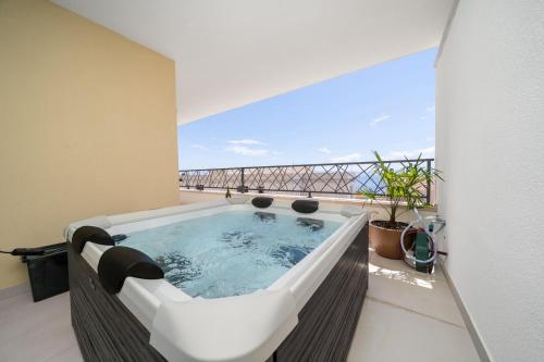 a hot tub on the balcony of a building at Luxury Residence Mauro in Makarska