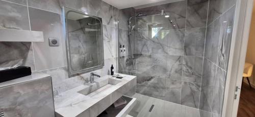 a bathroom with a sink and a shower at Hostellerie du Royallieu in Compiègne