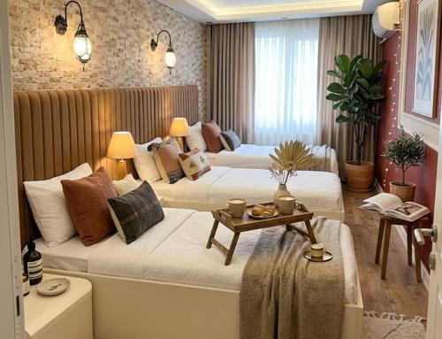 a hotel room with two beds and a table at elisa hotel in Istanbul