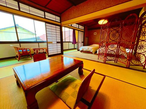 a room with a table and a bed and a bedroom at Japanese style hotel and dining Morigen, Kyoto by the sea in Kyotango