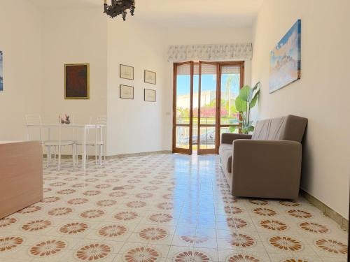 a living room with a couch and a table at Baia Verde - Dimitri House in Baia Verde