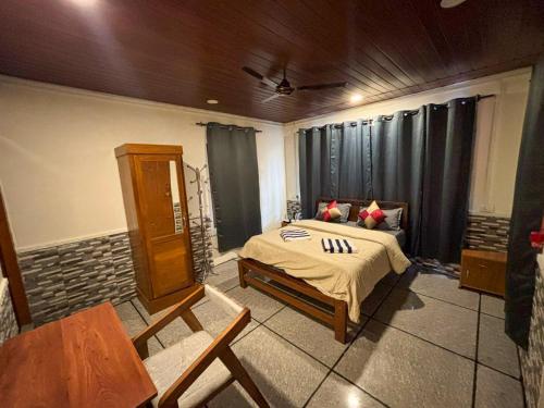 a bedroom with a bed and a table in it at Hope Hostels - Munnar in Munnar