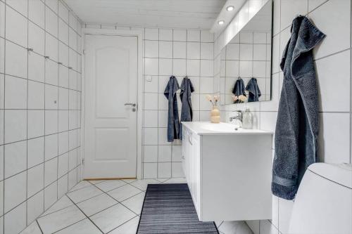 a white bathroom with a sink and a mirror at C11629-Hemmet-Ildervej-10 in Hemmet