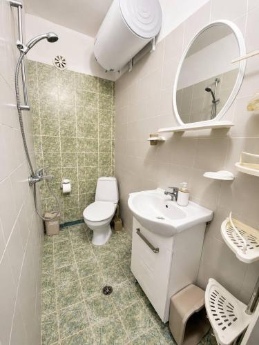 a bathroom with a toilet and a sink and a shower at Нашата къща in Sinemorets