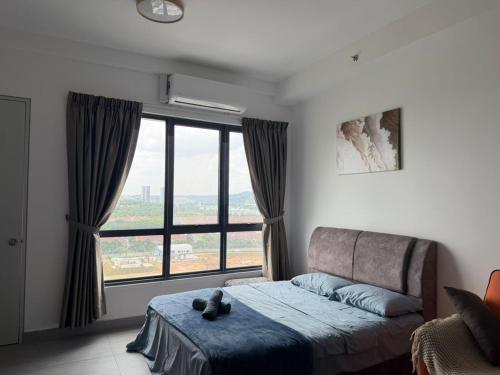 a bedroom with a bed and a large window at Cozy Stay Studio in Shah Alam