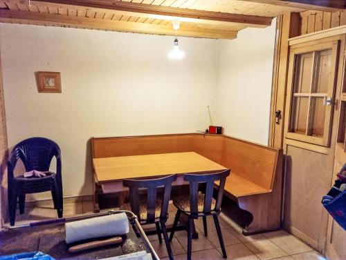 a wooden table and chairs in a room at Chalet Le Châtelaret by Interhome in Finhaut