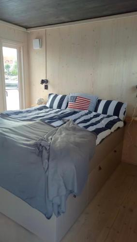 a bed in a room with an american flag on it at Unique floating retreat Sleeps 4 in Sölvesborg