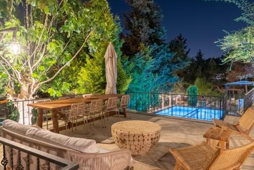 a patio with a table and chairs and a pool at Büyükada Apart Hotel in Adalar