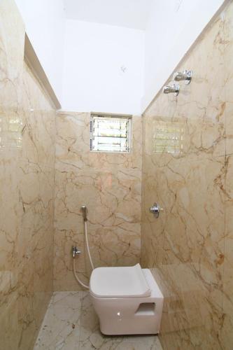 a bathroom with a toilet and a shower at Golden Palace in Kolkata