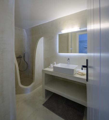 a bathroom with a sink and a mirror and a shower at GM Canava1916 in Megalochori