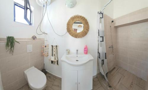 a bathroom with a sink and a toilet and a shower at Thea's Bungalow in Costinesti