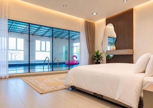 a bedroom with a large bed and a swimming pool at استراحة الوداد in Qurayyah