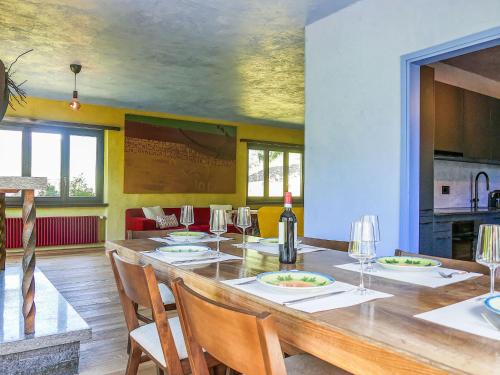 a dining room with a large wooden table with chairs at Apartment Casa Malva by Interhome in Malvaglia