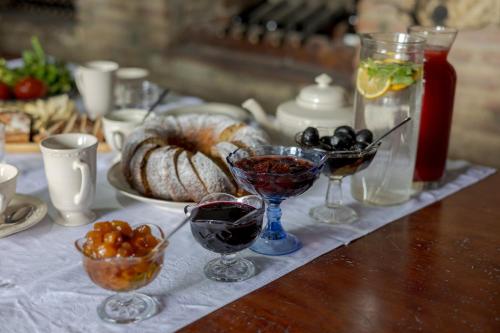 a table topped with glasses of wine and bread at Lurji Bani in Sighnaghi