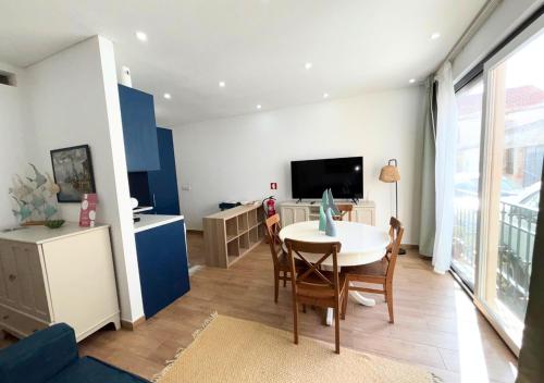 a living room with a table and a tv at Casa na Aldeia in Melides