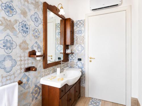 a bathroom with a sink and a mirror at B&B TORRE AZUL FRONTEMARE - Bisceglie in Bisceglie