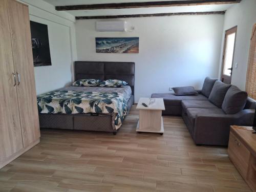 a living room with a bed and a couch at Apartmani Dumezic in Bar