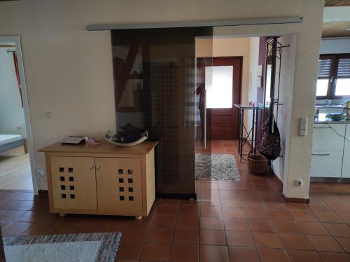 a living room with a tile floor and a kitchen at Schöner Wohnen in Rheinau