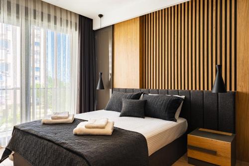 a bedroom with a large bed with two towels on it at Bliss Residance in Altınkum