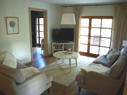 a living room with two couches and a table at Apartment Waldblick by Interhome in Bleckede