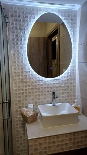 a bathroom with a sink and a mirror at MoSta Sunset in Litochoro