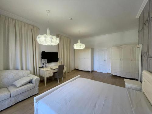 a living room with a bed and a desk at Olympia Sozopol in Sozopol