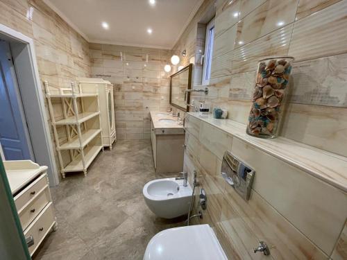 a bathroom with a white toilet and a sink at Olympia Sozopol in Sozopol
