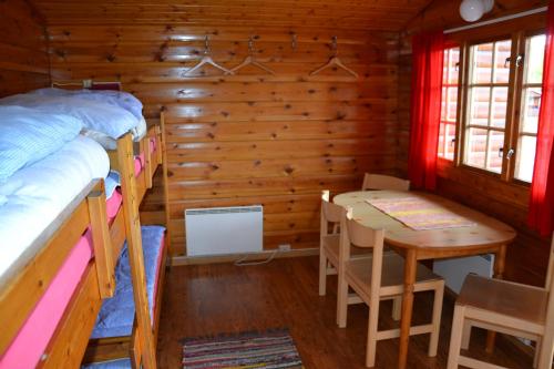 a bedroom with a table and a bed and a dining room at Alta River Camping in Alta