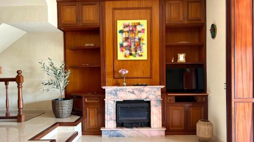 a living room with a fireplace and a television at la Casa de Flores in Tossa de Mar