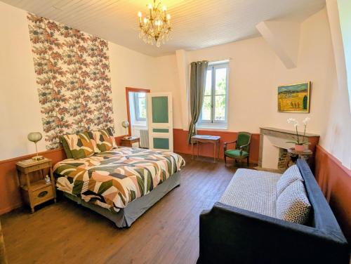 a bedroom with a bed and a couch at Domaine de la Dordrona in Brantome en Perigord
