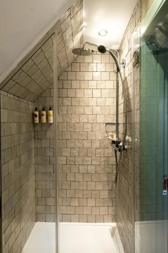 a shower with a glass door in a bathroom at The Swan in Arundel