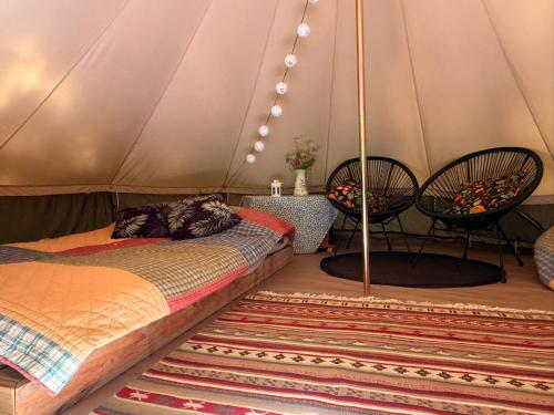 a bedroom with a bed in a tent at Naawa Nature Camp in Korppoo