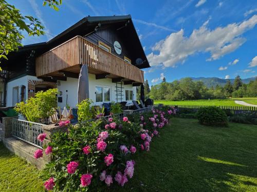 a house with flowers in front of it at Ferienhaus DaPfusterer in Bad Mitterndorf