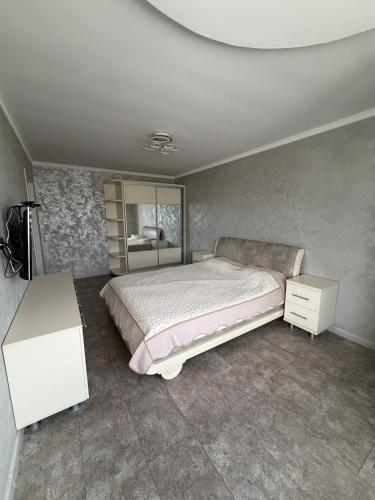 a bedroom with a large bed and a white dresser at Vila Lena S in Cahul