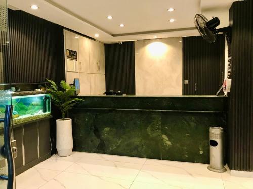 a bar in a restaurant with a fish tank at Hotel Islamabad Premiere Inn in Islamabad