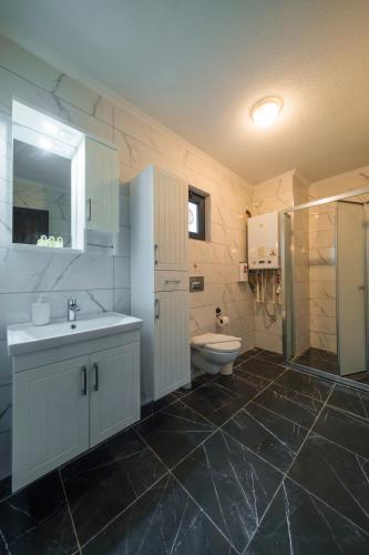 a bathroom with a sink and a toilet at Monk By The Lake Sapanca in Sapanca