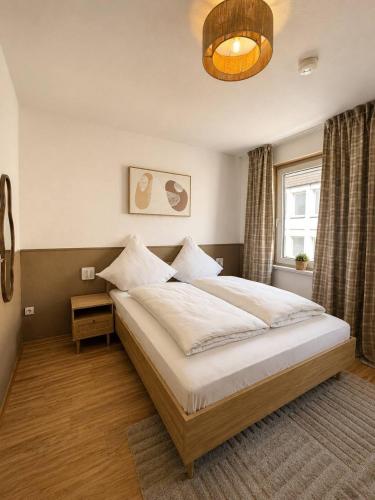 a bedroom with a large bed and a window at Shin Central Self-Check-in in Essen