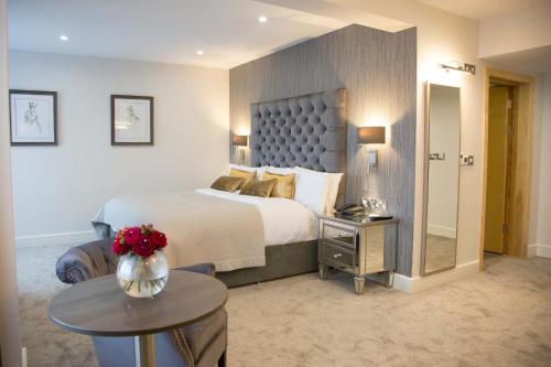 a hotel room with a large bed and a table at Westlodge Hotel & Leisure Centre in Bantry