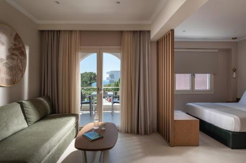 a hotel room with a bed and a couch at AMARÉ suites in Nikiti