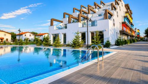 a building with a swimming pool in front of it at WRW Airport Residence in Otopeni