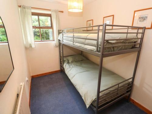 a bunk bed room with two bunk beds at Swallow Cottage in Helston