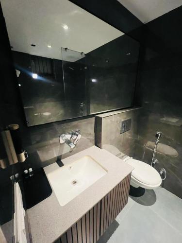 a bathroom with a sink and a toilet at Hotel Cassa Inn in Bathinda