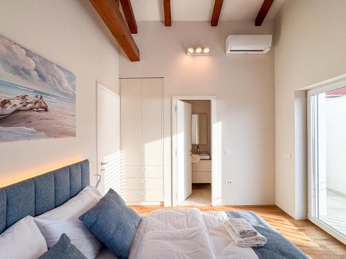a bedroom with a bed and a large window at Gloria Holiday - Casa Bianca in Piran