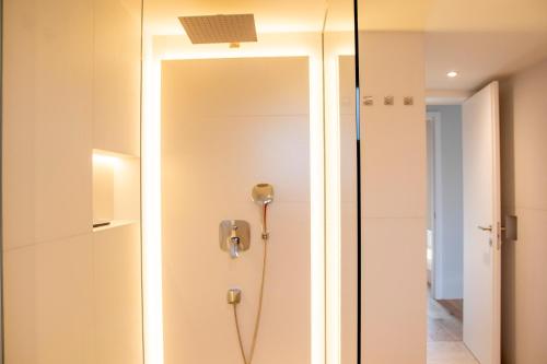 a bathroom with a shower and a mirror at Gloria Holiday - Casa Bianca in Piran
