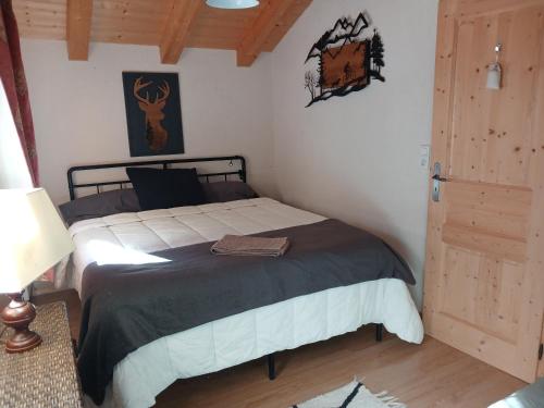a bedroom with a bed in a room with a door at "NAMASTE" Chambre zen au calme in Saint-Jean-d'Aulps