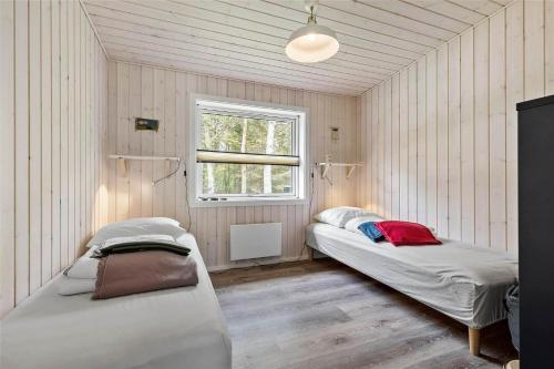 a room with two beds and a window at 8245-Knebel-Metholmvej-9 in Knebel