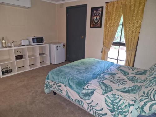 a bedroom with a bed and a window at Private Studio Ensuite & Kitchenette in Glen Waverley
