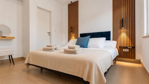a bedroom with a large bed with towels on it at Villa Aquiterra Bobovisca in Bobovišća