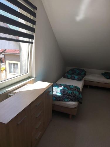 a small room with two beds and a window at Pokoje gościnne in Lubniewice